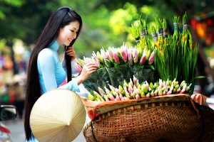 Vietnamese girls wear Ao Dai to visit Flower Market